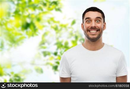expression and people concept - man with funny face over green natural background. man with funny face over green natural background