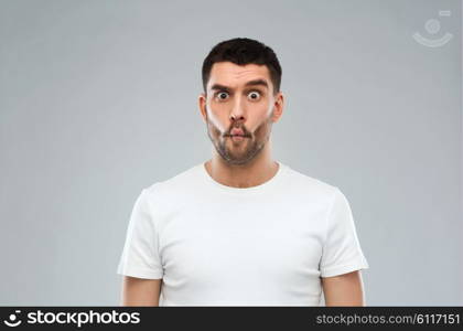 expression, fun and people concept - man with funny fish-face over gray background