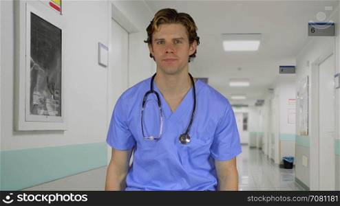 Expressionless male medical worker in a hospital