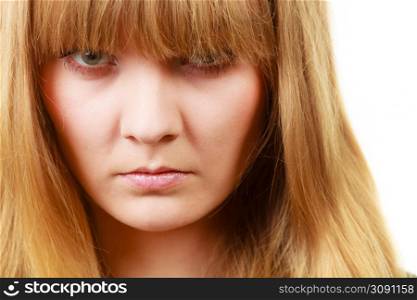 Expressions, emotions, anger, mysterious concept. Angry looking woman, face covered in her blonde fringe. Angry looking woman, face covered in fringe