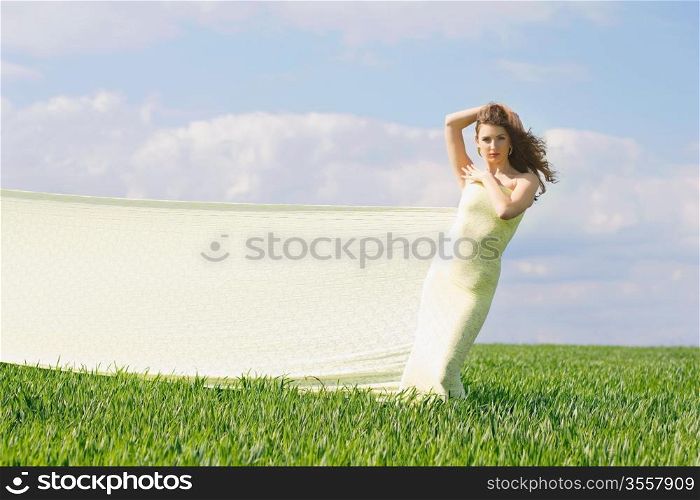 Expressive attractive girl in a green field
