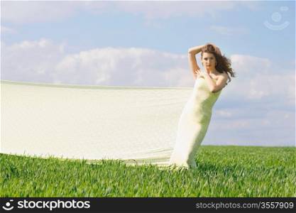 Expressive attractive girl in a green field
