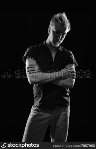 Expressive handsome young man - studio shot, black and white image, black background
