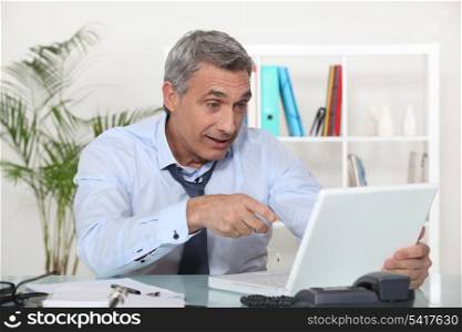 expressive worker in front of computer