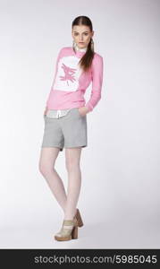 Expressive young model in casual style on gray background.