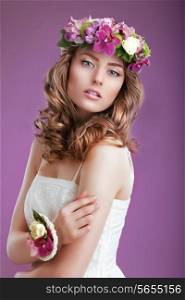 Exquisite Woman with Wreath of Flowers. Elegant Lady with Frizzy Hair