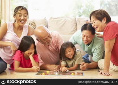 Extended Family Group Playing Board Game At Home