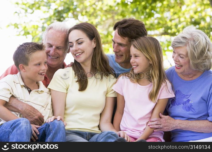 Extended family outdoors smiling