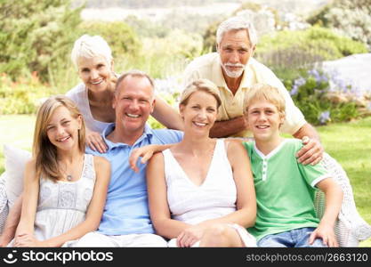 Extended Family Relaxing In Garden