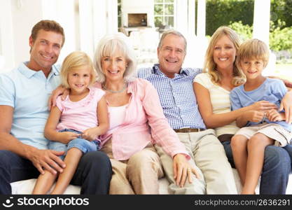 Extended Family Relaxing Together On Sofa