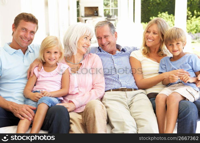 Extended Family Relaxing Together On Sofa