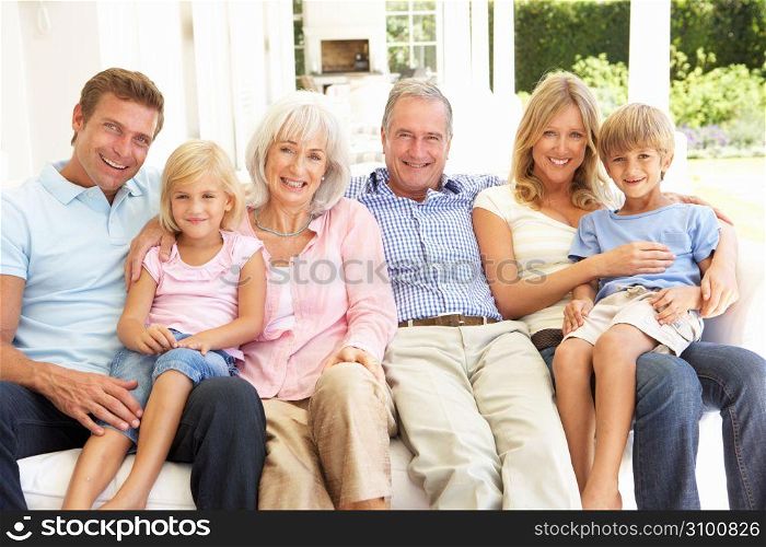 Extended Family Relaxing Together On Sofa
