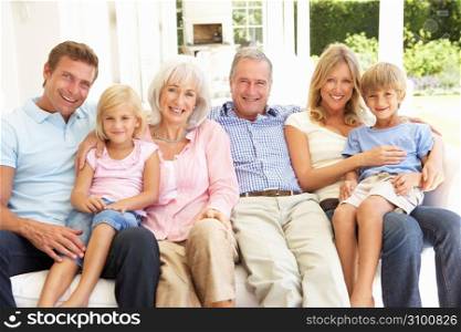 Extended Family Relaxing Together On Sofa