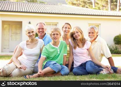 Extended Family Sitting Outside Dream Home