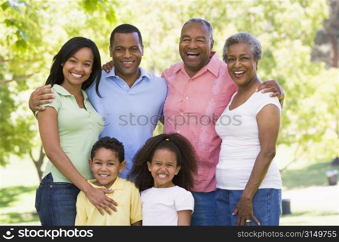 Extended family standing in park smiling