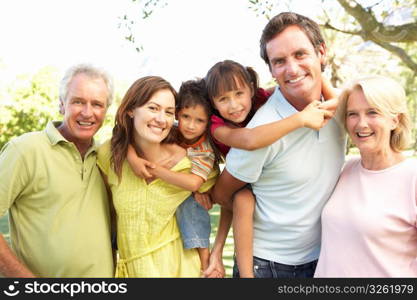 Extended Group Portrait Of Family Enjoying Day In Park