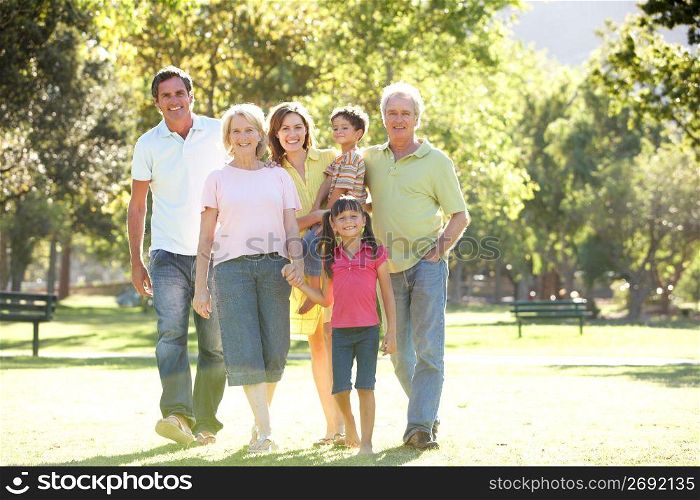 Extended Group Portrait Of Family Enjoying Walk In Park