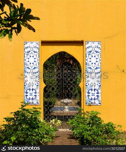 Exterior door architecture in morocco style on bright yellow color wall background.
