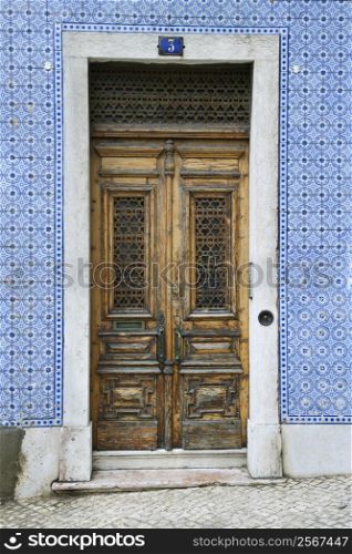 Exterior doors and tiled building in Lisbon, Portugal.