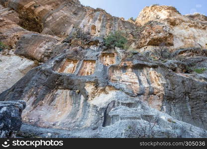 Exterior facade view of Adamkayalar,literally means man-rocks which located on top of Toros Mountains in Silifke,Mersin,Turkey.. Exterior facade view of Adamkayalar or man rocks