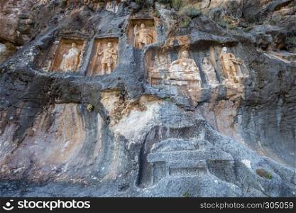 Exterior facade view of Adamkayalar,literally means man-rocks which located on top of Toros Mountains in Silifke,Mersin,Turkey.. Exterior facade view of Adamkayalar or man rocks