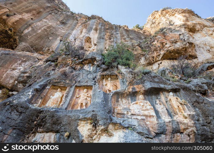 Exterior facade view of Adamkayalar,literally means man-rocks which located on top of Toros Mountains in Silifke,Mersin,Turkey.. Exterior facade view of Adamkayalar or man rocks