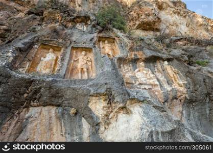Exterior facade view of Adamkayalar,literally means man-rocks which located on top of Toros Mountains in Silifke,Mersin,Turkey.. Exterior facade view of Adamkayalar or man rocks