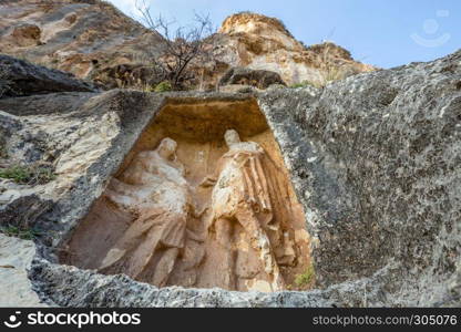 Exterior facade view of Adamkayalar,literally means man-rocks which located on top of Toros Mountains in Silifke,Mersin,Turkey.. Exterior facade view of Adamkayalar or man rocks