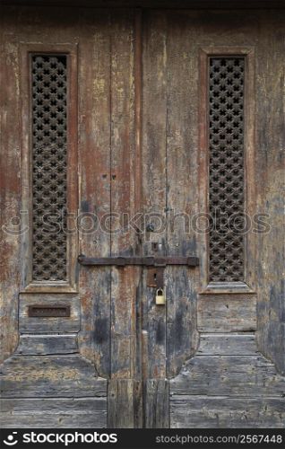 Exterior locked doors with worn paint in Lisbon, Portugal.