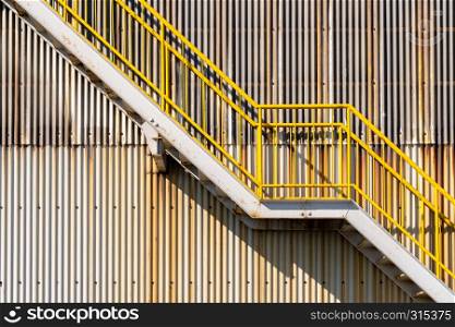 exterior of metal sheet warehouse wall and fire exit stair