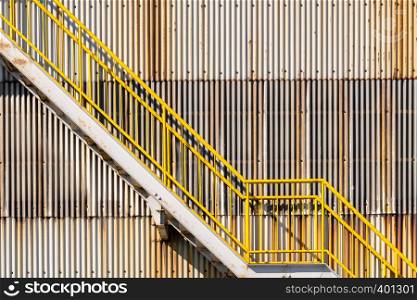 exterior of metal sheet warehouse wall and fire exit stair