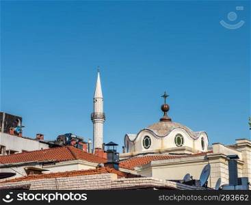 Exterior view of Armenian Surp Takavor Church and mosque minaret together,Istanbul,Turkey.Peace concept
