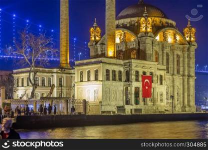 Exterior view of Ortakoy Mosque with15 July Martyrs Bridge or unofficially Bosphorus Bridge also called First Bridge over bosphorus in Istanbul,Turkey.03 January 2018. Exterior view of Ortakoy Mosque with15 July Martyrs Bridge