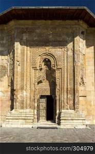 Exterior view of Sivas Divrigi Great Mosque and Praying man silhouette on gate. Exterior view of Sivas Divrigi Great Mosque