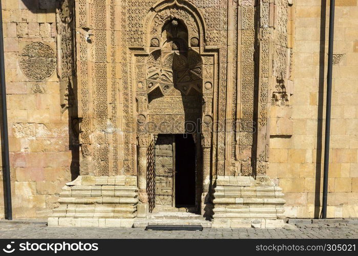 Exterior view of Sivas Divrigi Great Mosque and Praying man silhouette on gate. Exterior view of Sivas Divrigi Great Mosque