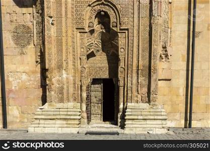 Exterior view of Sivas Divrigi Great Mosque and Praying man silhouette on gate. Exterior view of Sivas Divrigi Great Mosque