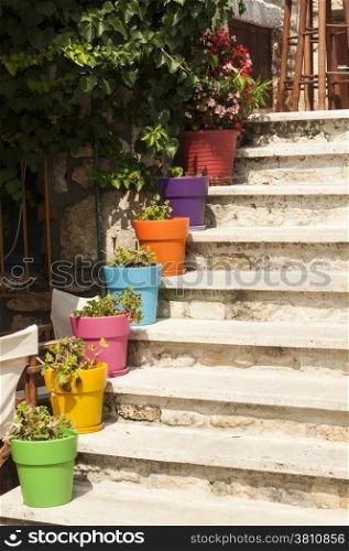 External staircase of house with colorful flowerpots
