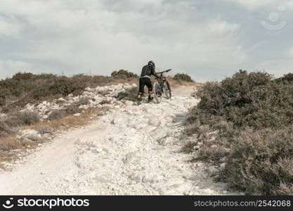 extra long shot man riding mountain bike