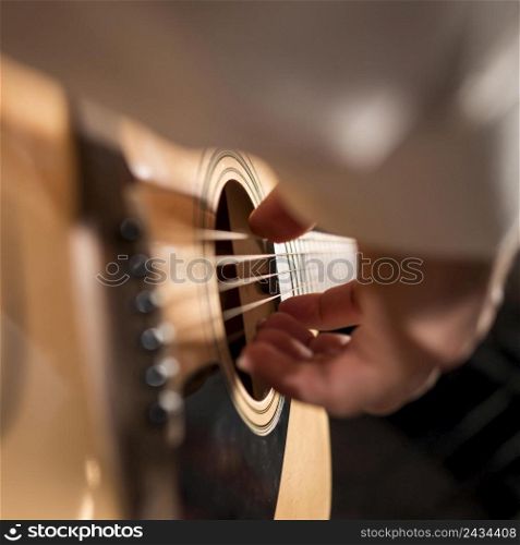 extreme close up man person playing guitar