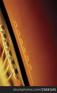 Extreme close-up of guitar bridge and strings