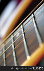 Extreme close-up of guitar frets and strings