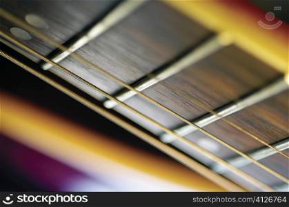 Extreme close-up of guitar frets and strings