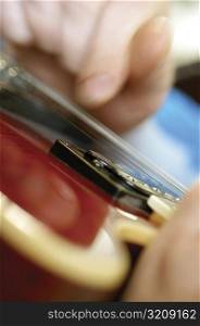 Extreme close-up of man playing electric guitar