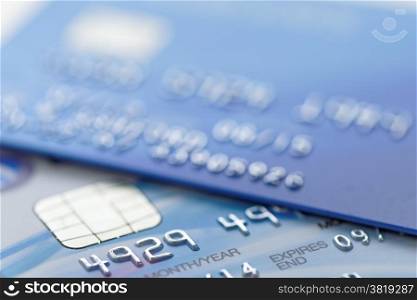Extreme close up of part of a credit card with shallow depth of field. Account number changed for security