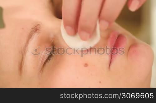 Extreme close-up shot of cosmetician providing ultrasonic cleaning of a nose
