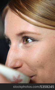 Extreme closeup of a woman drinking tea