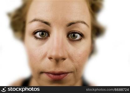 Extreme closeup of a young woman in front of white background
