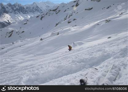 extreme freeride skier skiing on fresh powder snow in downhill at winter mountains