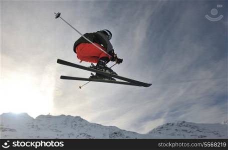 extreme freestyle ski jump with young man at mountain in snow park at winter season