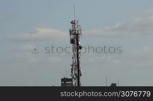 Extreme long shot of a big telecommunications antenna tower day time lapse with no birds in it.